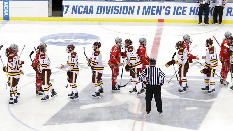 The Minnesota-Duluth and the Ohio State teams shake hands after their overtime of an NCAA West...