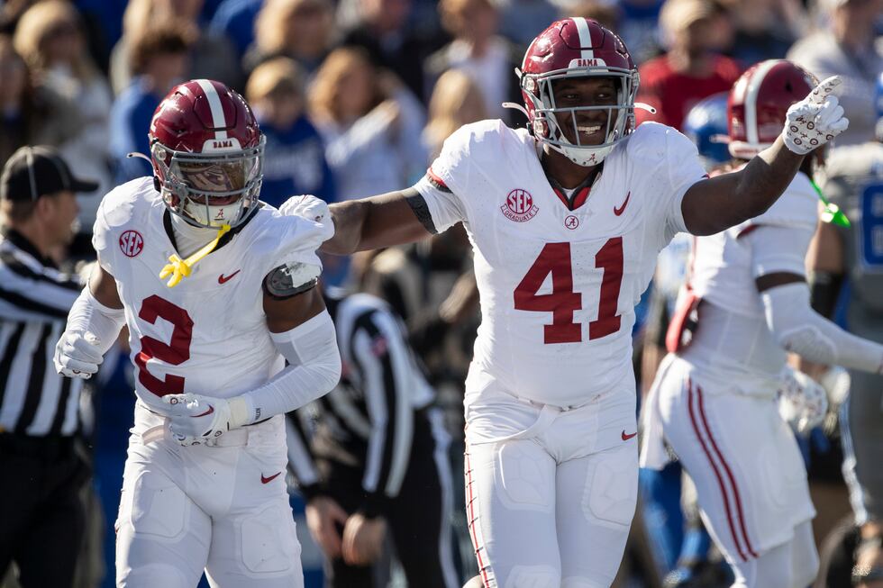 Alabama defensive back Caleb Downs (2) and linebacker Chris Braswell (41) celebrate a fumble...