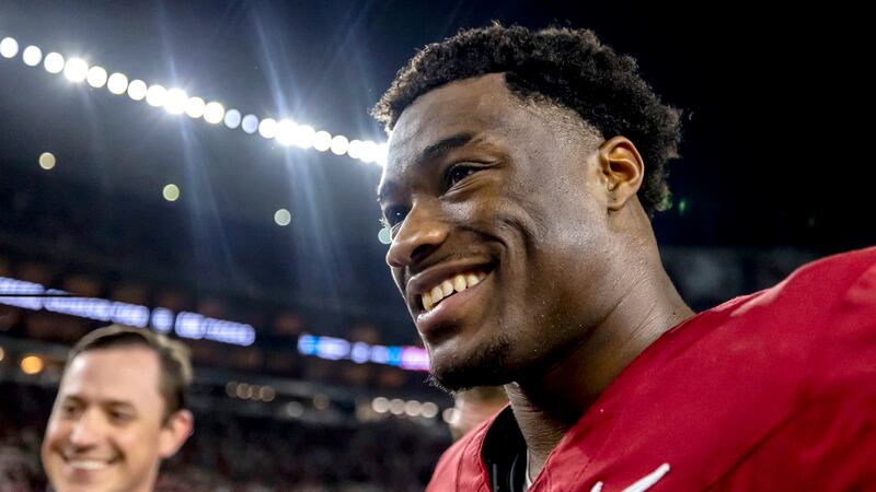Alabama quarterback Jalen Milroe smiles as he departs the field with a win over LSU after an...