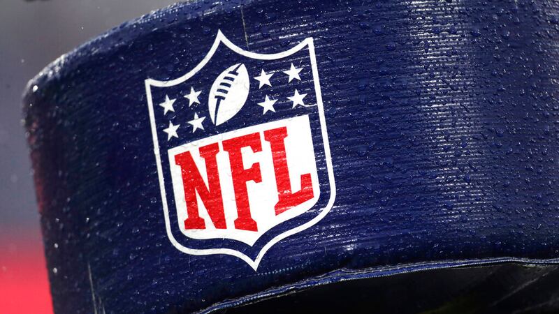 FILE - In this Dec. 1, 2019, file photo, rain drops are seen on the NFL logo on padding of a...