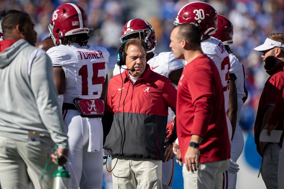 Alabama head coach Nick Saban stands in a huddle during the first half of an NCAA college...