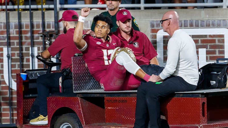 Florida State quarterback Jordan Travis is taken off the field after being injured during the...