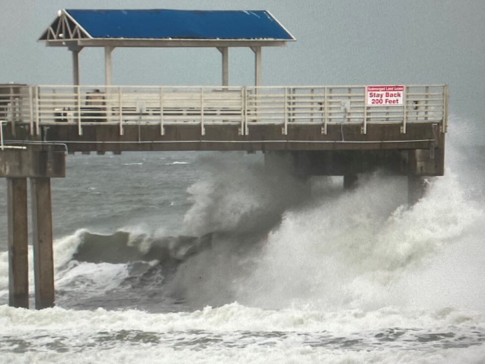 Large waves crashes through the pilings on the end of Four Seasons Pier in Orange Beach