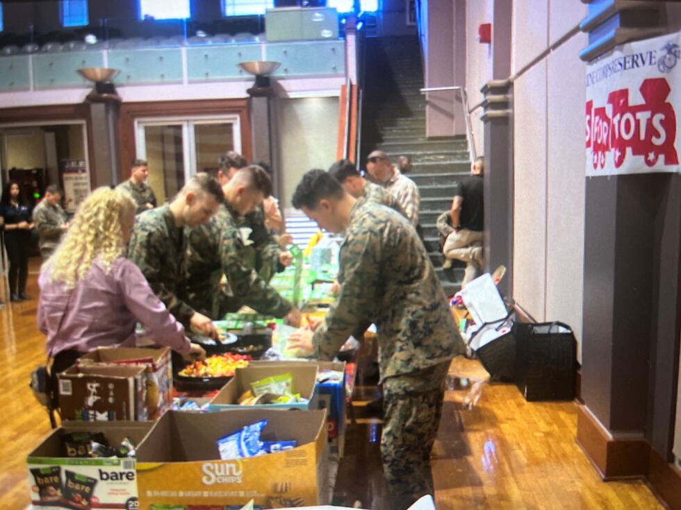 Marines from the 3rd Force Reconnaissance Company and their families enjoy a meal together as...